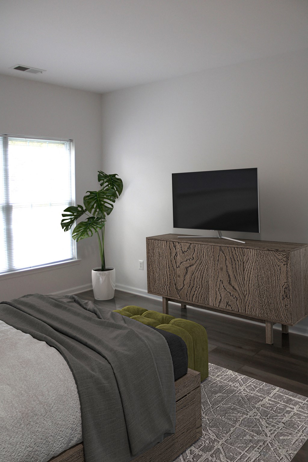 a bedroom with a bed and a television on a dresser
