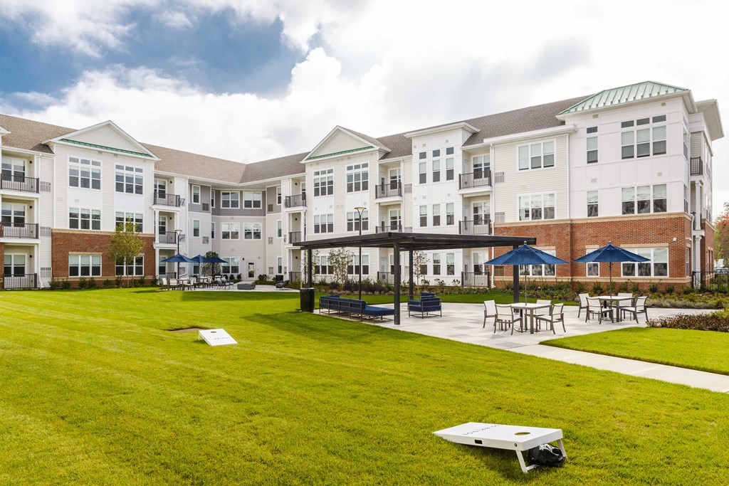 Building exterior with sitting area and lawn at 99 Bridge, New Jersey, 08857