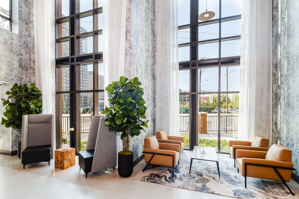 a lobby with couches and chairs and large windows at 100 House Apartments, Jersey City , NJ, 07310