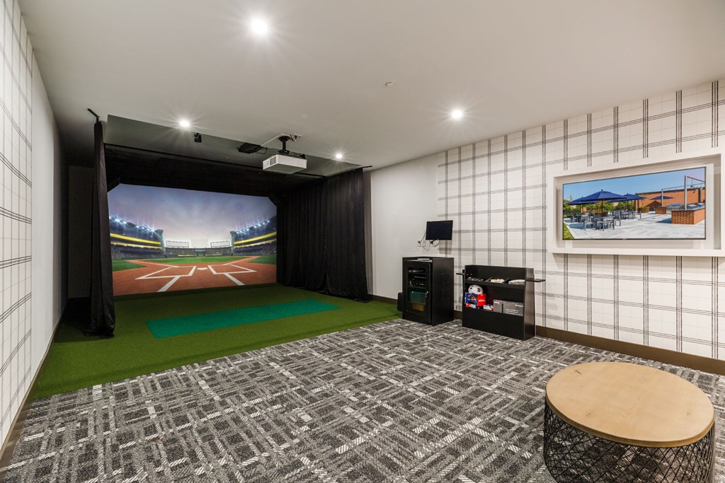 a living room with a large screen tv and a green rug at 100 House Apartments, Jersey City , 07310