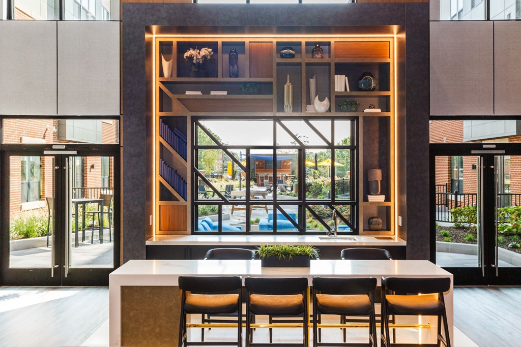 a dining room with a table and chairs in front of a window at 100 House Apartments, Jersey City , New Jersey