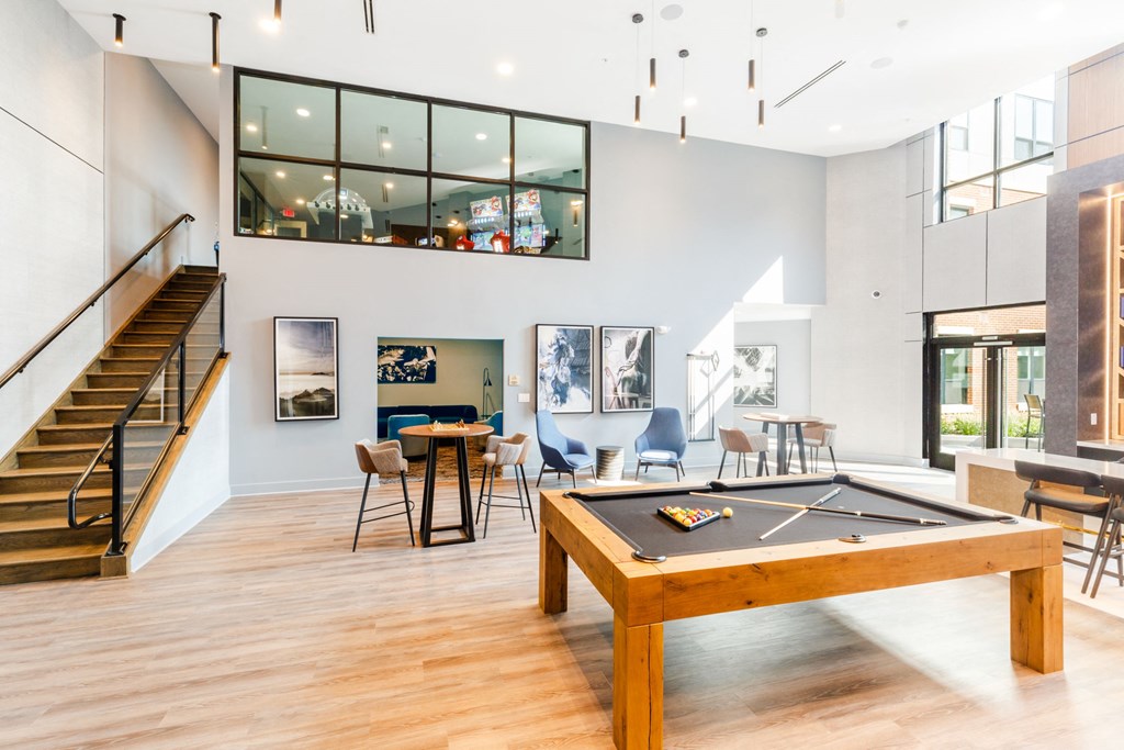 a game room with a pool table and a staircase at 100 House Apartments, Jersey City