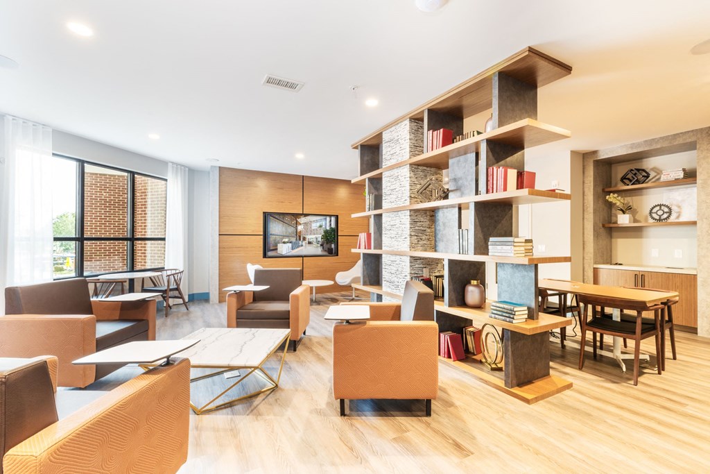 a living room filled with furniture and a book shelf at 100 House Apartments, Jersey City