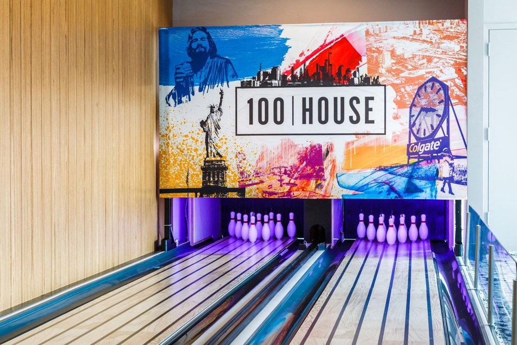 a bowling alley with bowling pins and a sign that reads 100 house at 100 House Apartments, Jersey City , NJ, 07310