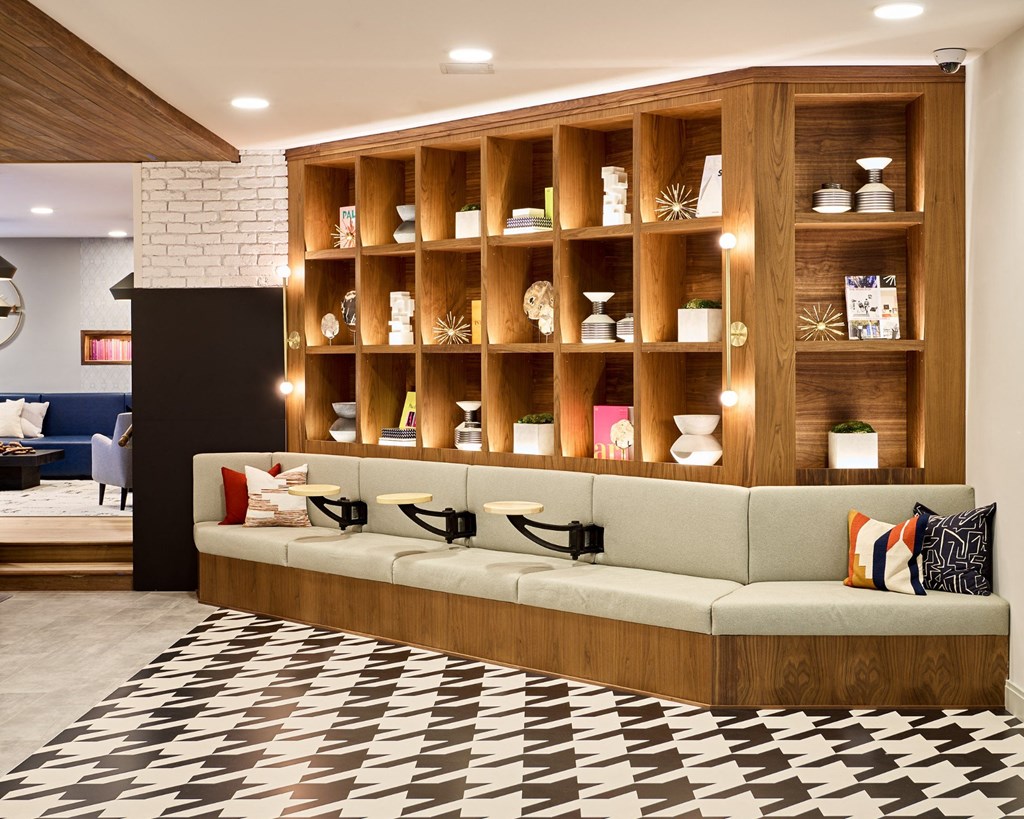 a living room with a couch in front of a wall with shelves