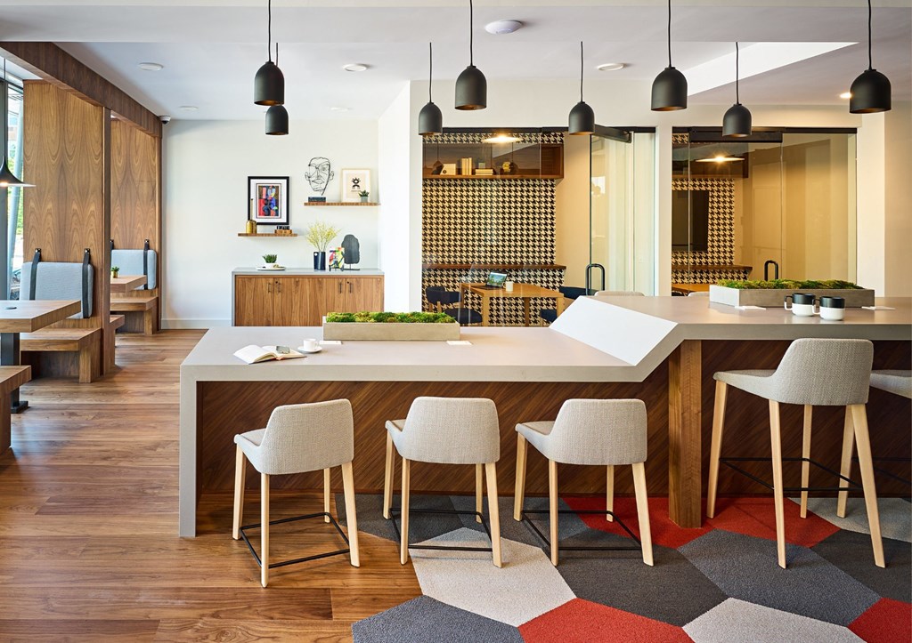 a large kitchen with a large island and chairs in front of it