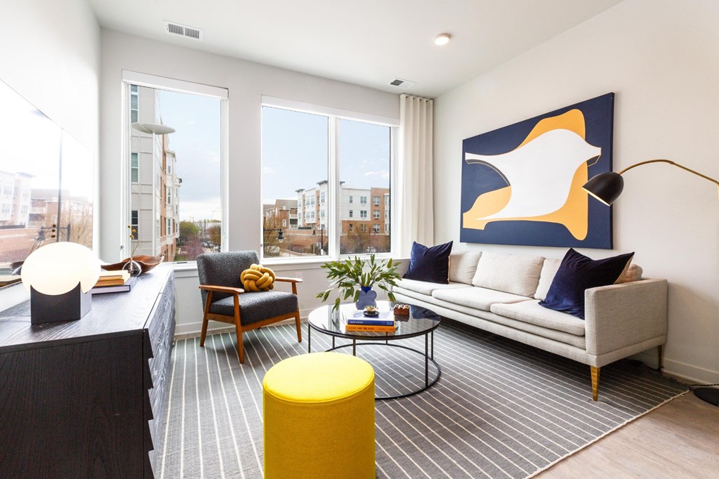 a living room with a white couch and a large window