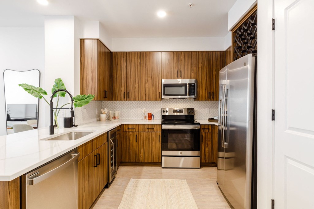 a kitchen with wooden cabinets and stainless steel appliances