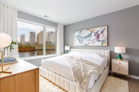 a bedroom with a large window and a white bed at Dey & Bergen, New Jersey, 07029
