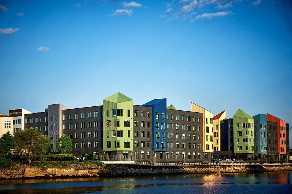 a row of buildings sitting next to a body of water