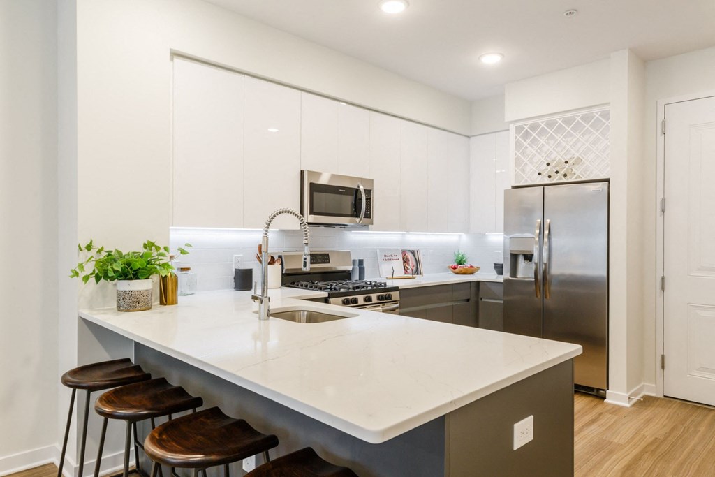 a kitchen with stainless steel appliances and an island with stools