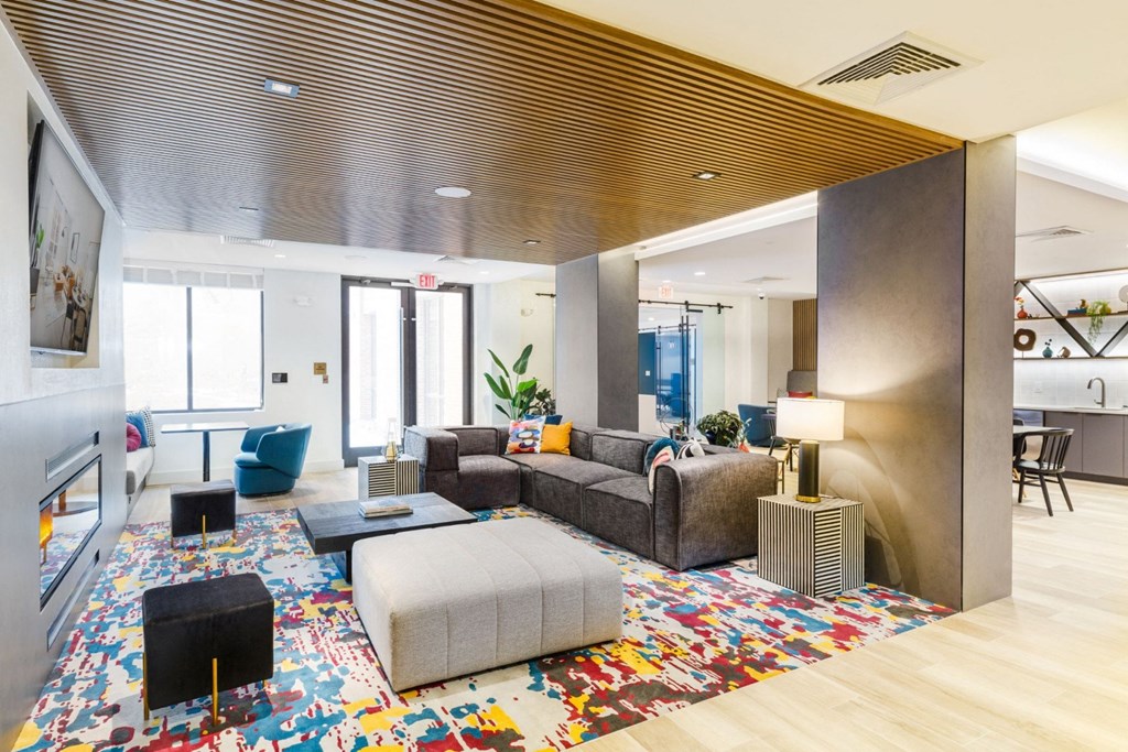 a living room with couches and chairs and a rug
