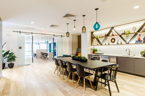 a dining room and kitchen with a table and chairs at One Ten Apartments, New Jersey