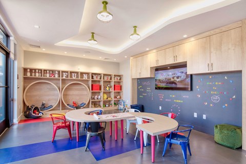 a childs play room with a table and chairs at One Ten Apartments, Jersey City
