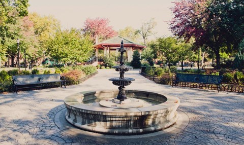 a fountain in a park with benches and a gazebo at One Ten Apartments, New Jersey, 07310