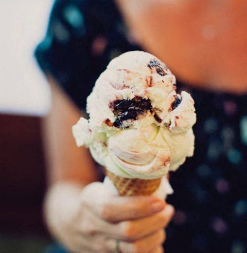 a person holding a cone with ice cream at One Ten Apartments, New Jersey
