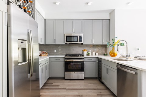 a kitchen with stainless steel appliances and white cabinets