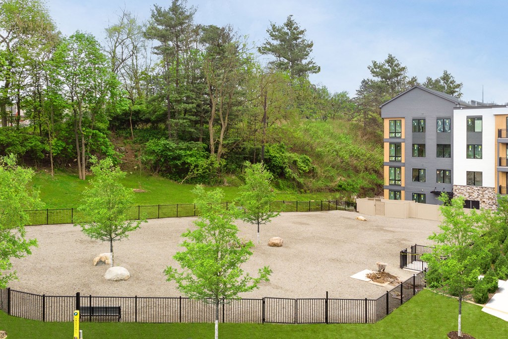 an aerial view of the courtyard of an apartment building with a playground and trees