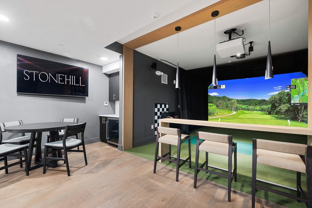 a dining room with a bar and a large screen tv