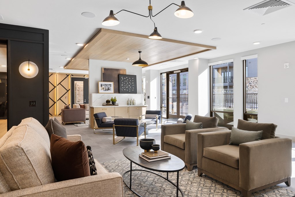 a living room with couches and chairs and a table
