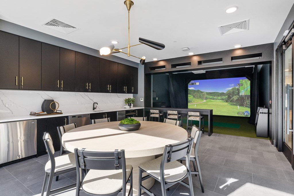 a dining room with a table and chairs and a large screen tv