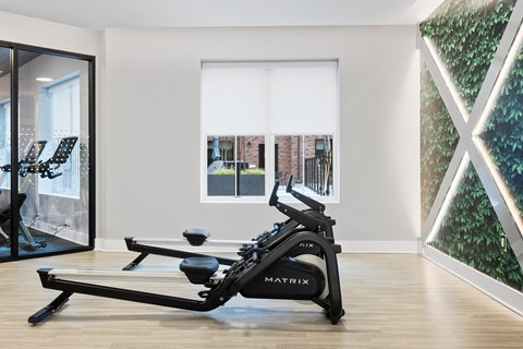 a gym room with a reformer exercise bike and a window at The Ivy, Chatham