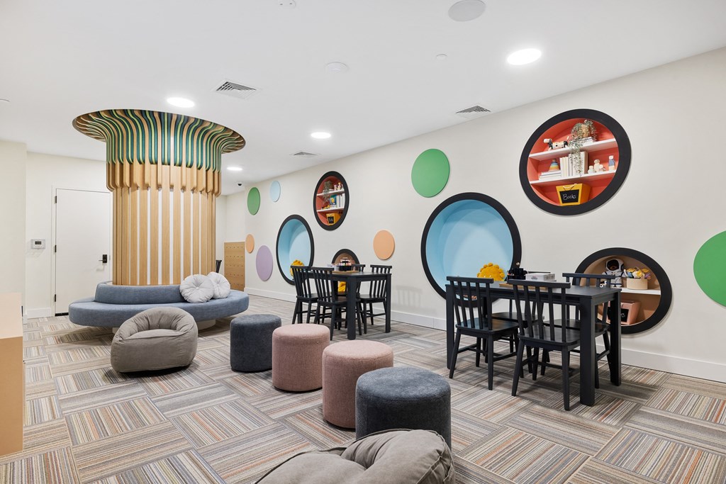 a living room with tables and chairs and a pillar at The Ivy, New Jersey, 07928