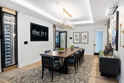 a dining room with a long table and chairs and a chandelier at The Ivy, Chatham, 07928