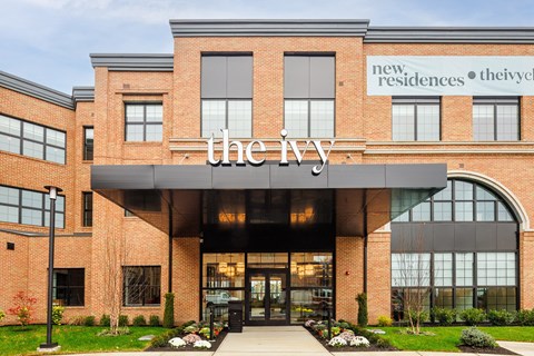 the new headquarters of the ivy is in a brick building with a large sign at The Ivy, Chatham, NJ