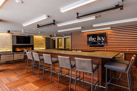 a restaurant with a bar and a fireplace at The Ivy, Chatham, NJ