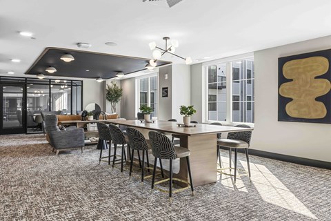 A modern dining room with a long table and chairs.