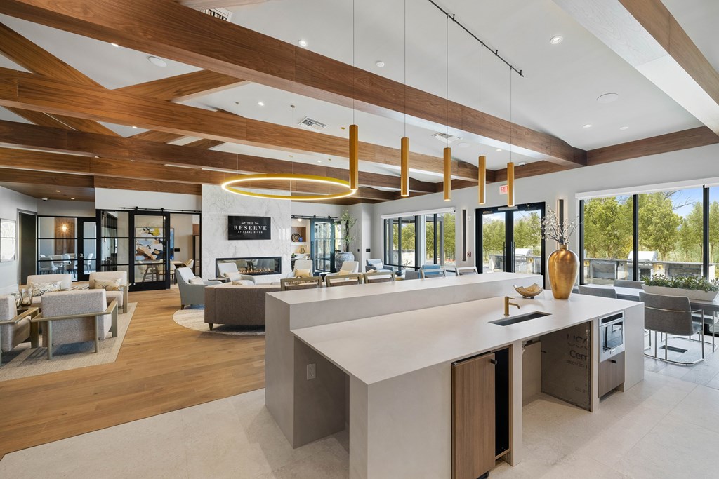 A modern kitchen with a large island and a dining area at The Reserve at Pearl River Apartments, Pearl River, NY
