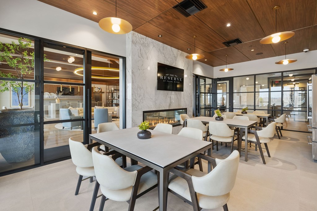 A modern dining room with a large table and chairs at The Reserve at Pearl River Apartments, New York, 10965
