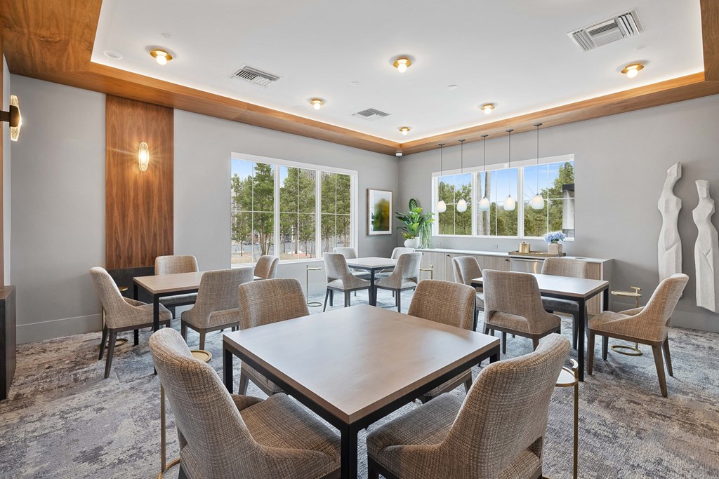 A room with a long table surrounded by chairs at The Reserve at Pearl River Apartments, New York