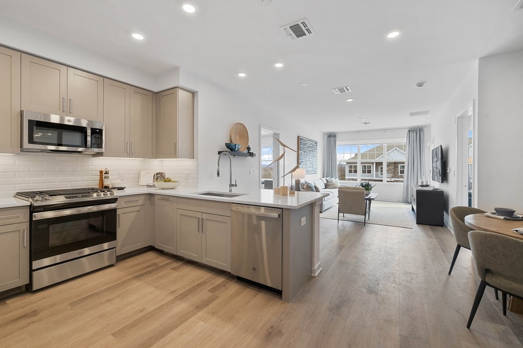 A modern kitchen with wooden floors and stainless steel appliances at The Reserve at Pearl River Apartments, Pearl River, 10965