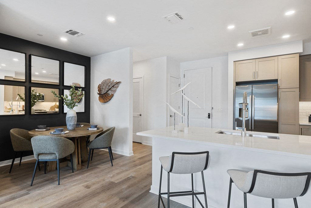 A modern kitchen with a dining table and chairs at The Reserve at Pearl River Apartments, Pearl River, NY