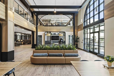 A large open space with a long couch and a wooden floor.