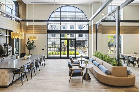 A large, modern dining area with a long table and chairs.