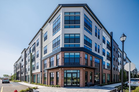 A modern multi-story building with a mix of brick and glass exterior.