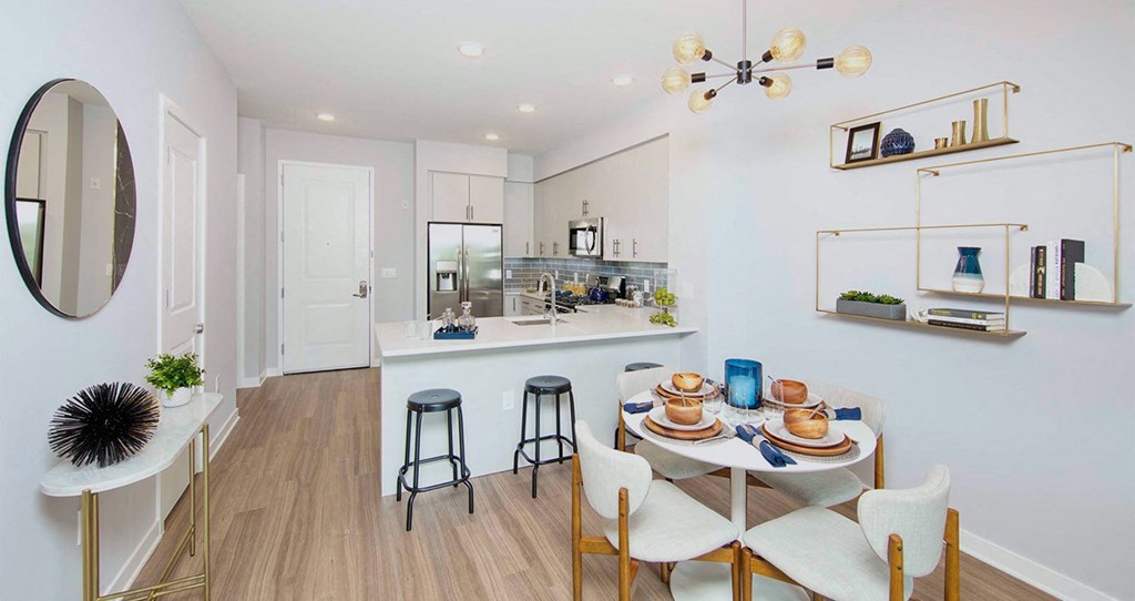 a dining area with a table and chairs next to a kitchen