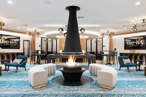 a lobby with chairs and a fire pit at The Ivy, Chatham, 07928