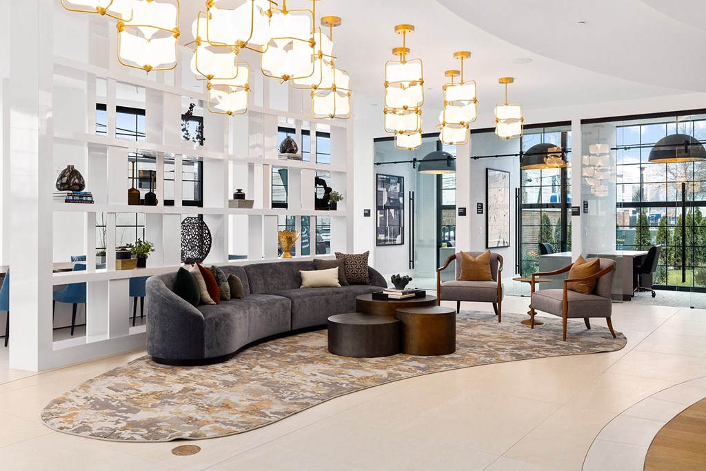 a large living room with a gray couch and chairs at The Ivy, Chatham, NJ