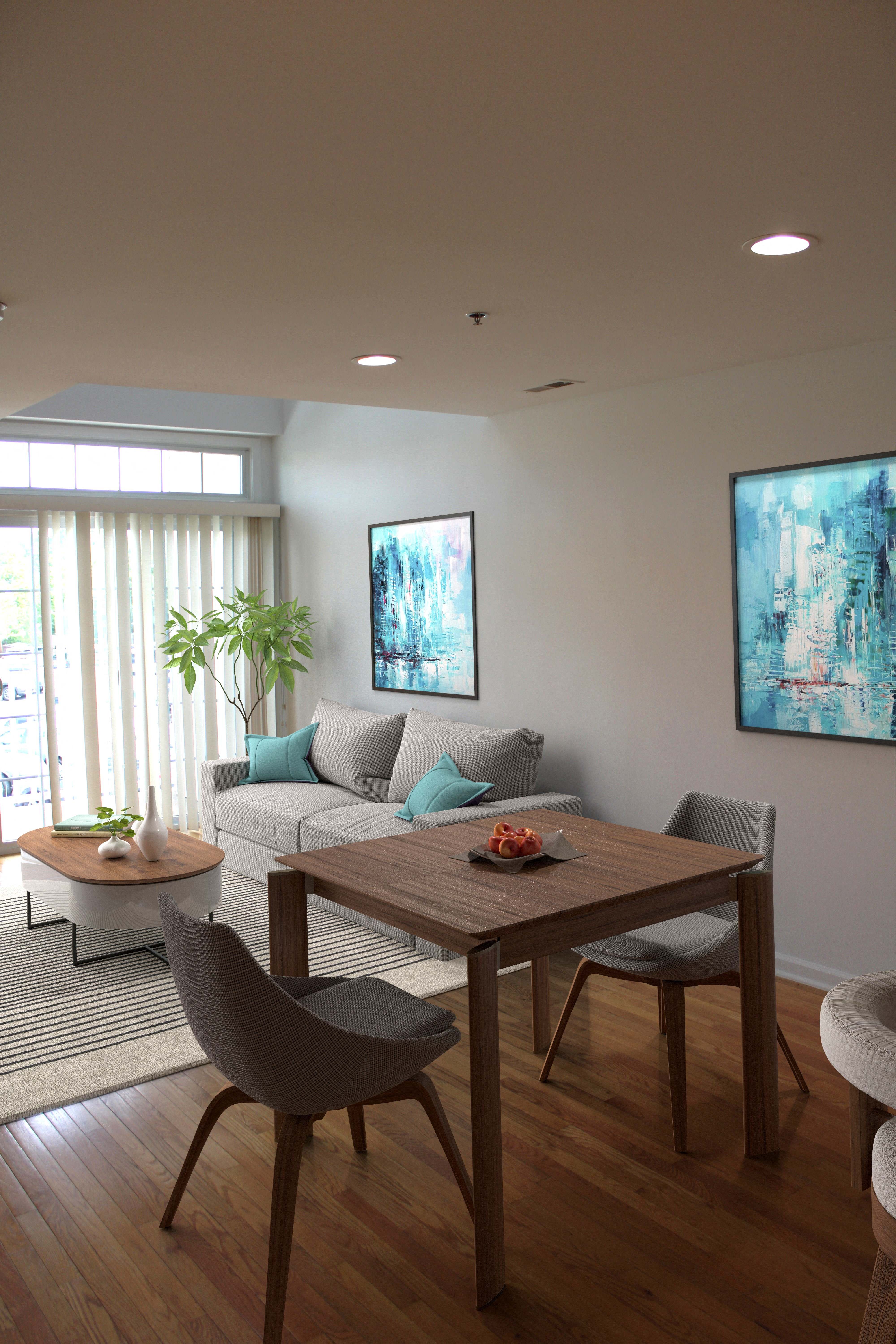 A modern dining room with a wooden table and chairs.