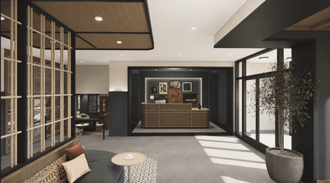 A modern living room with a dark grey sofa and a wooden coffee table.