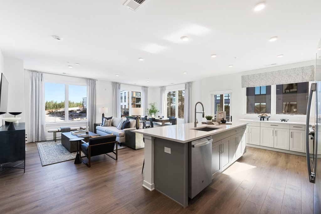 a kitchen with a large island in the middle of a living room