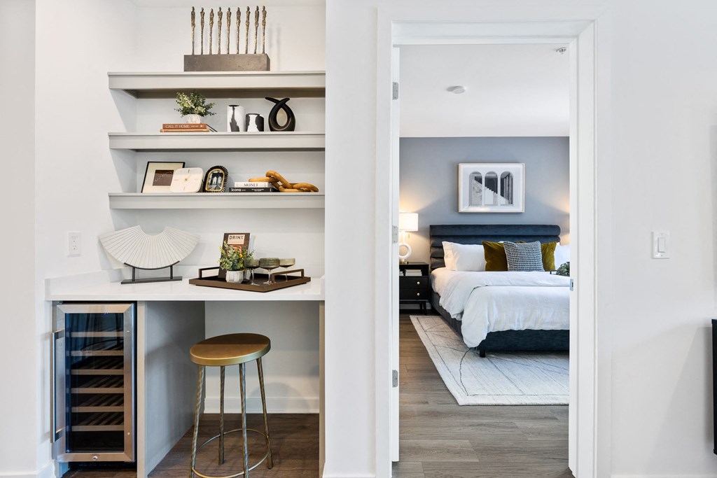 a bedroom with a bed and shelves and a stool