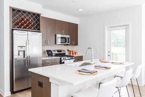 a kitchen with stainless steel appliances and a white counter top