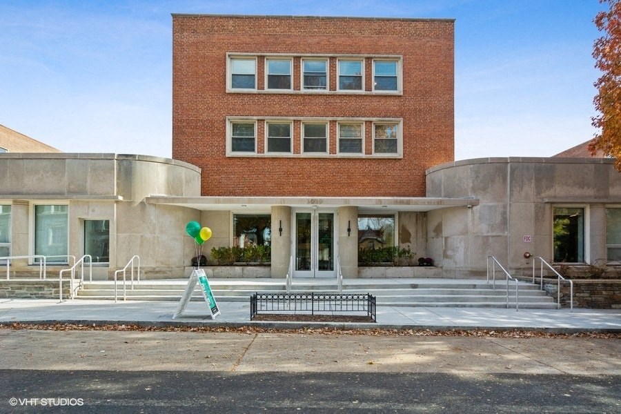 a building with a bench in front of it  at Carver and Slowe Apartments, Washington, Washington, DC 20001