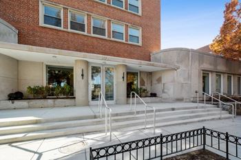 a large brick building with a staircase in front of it at Carver and Slowe Apartments, Washington Washington, DC