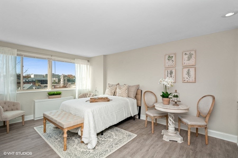 a bedroom with a large bed and a large window